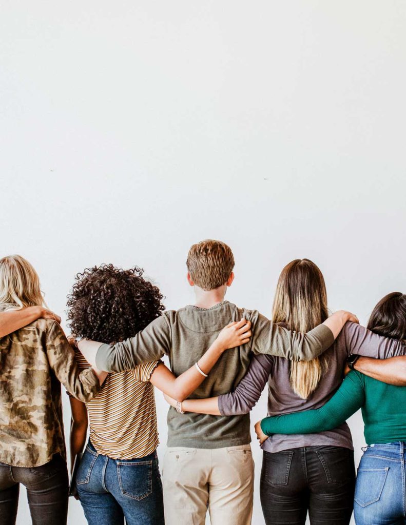 A view of a group of people with their arms on each others shoulders from the back